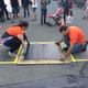 Illustration for article titled Watch a 7-Ton Steamroller Make an Oversized Print on the Street
